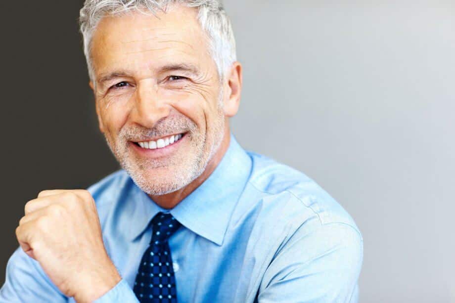 Man smiling dental implants dentures 920x613