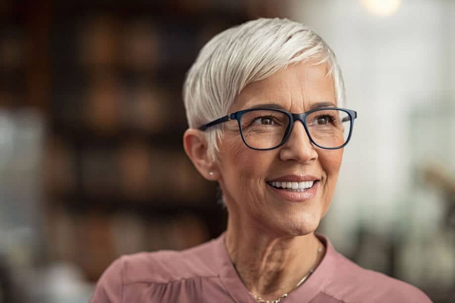Mature woman smiling dental implants 920x613