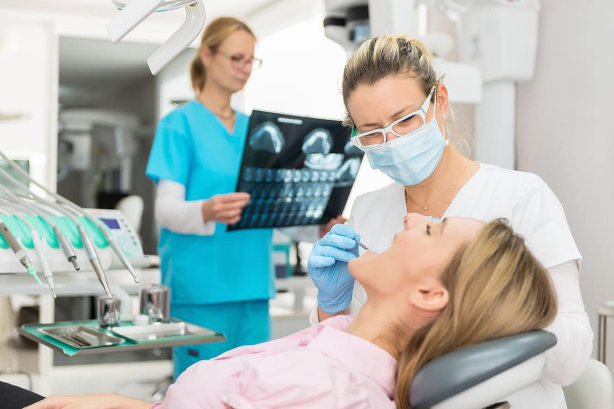 Patient getting checked by dentist image