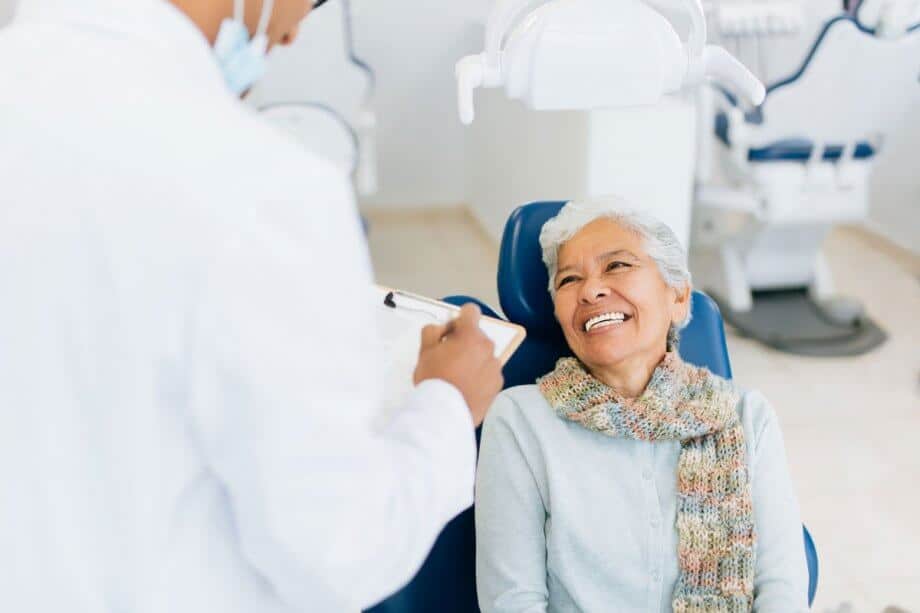 Senior woman in dental chair 920x613